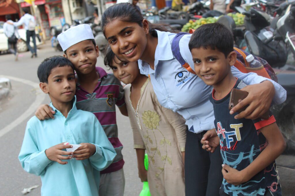 reality tour guide posing with local kids