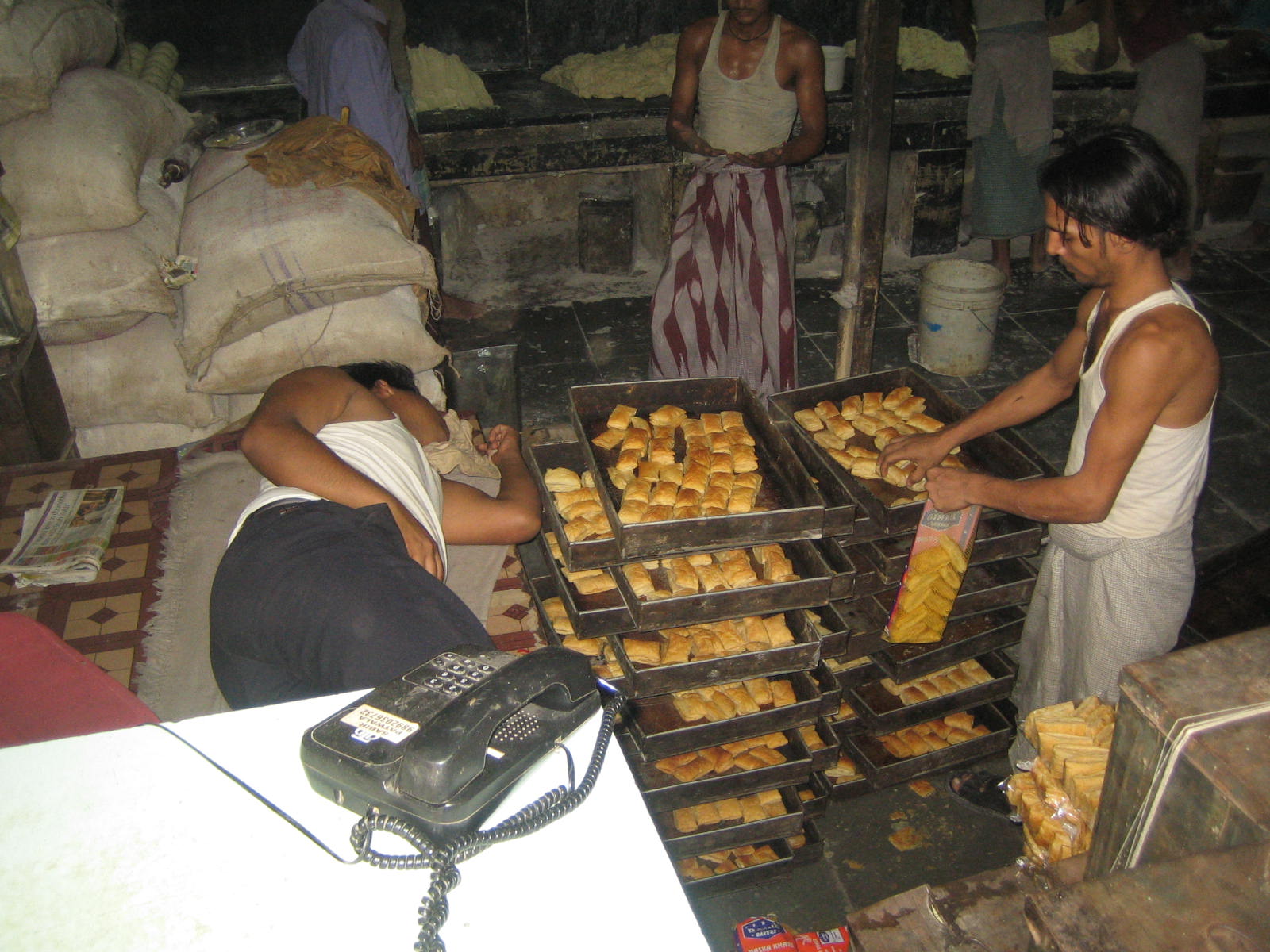 dharavi bakery employee packing puffs.