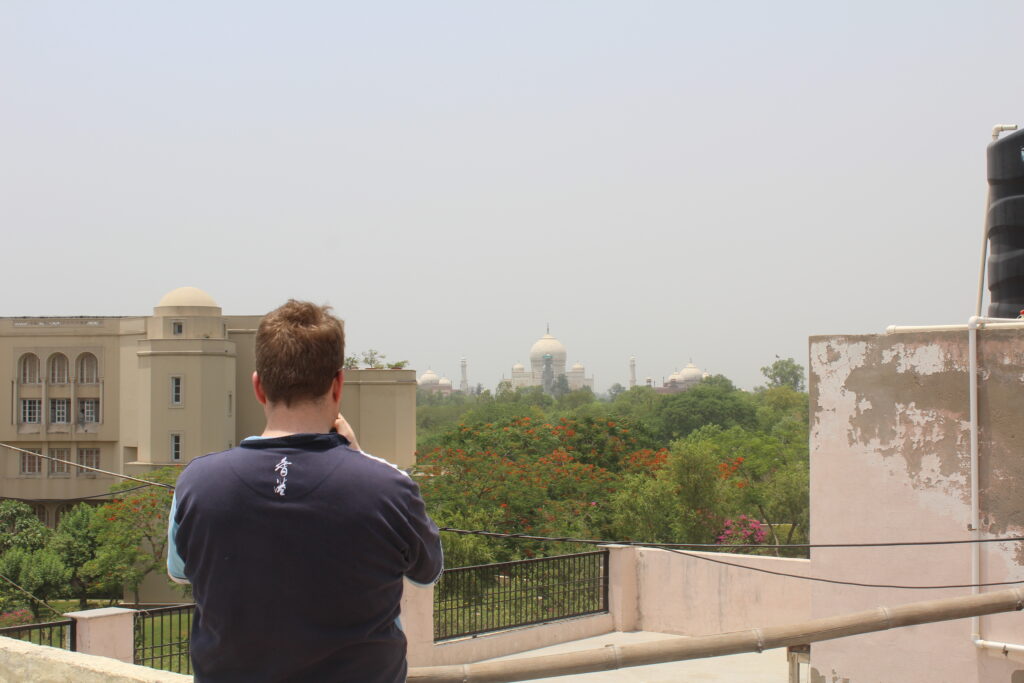 Tourist looking at Taj Mahal from his terrace - Friendly Golden Triangle Tour
