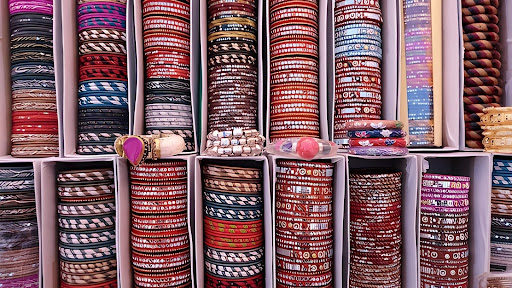 Stacks of colorful Indian bangles displayed in a local Jaipur market, showcasing traditional Rajasthani craftsmanship.