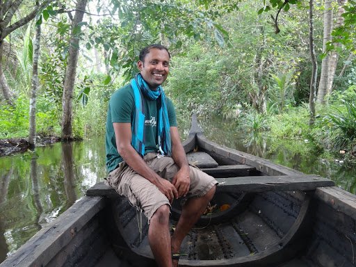 Krishna, co-founder of Reality Tours, with travellers on a guided tour in the Kerala backwaters of India