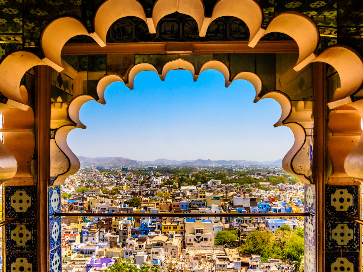 Pink City skyline framed by an ornate archway at Nahargarh Fort during a Jaipur Heritage Tour.