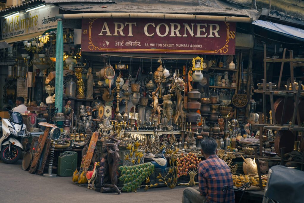 A cluttered storefront of "Art Corner" in Mumbai's Chor Bazaar, overflowing with various antiques, curios, and artifacts.