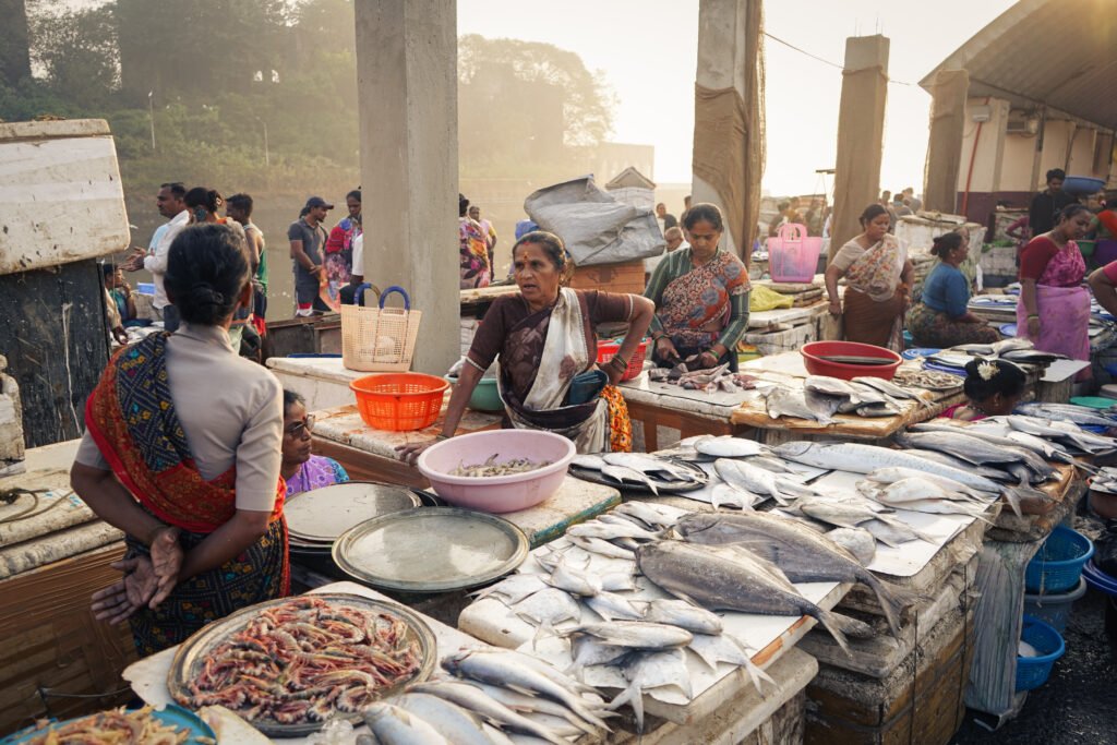 The image showcases the bustling atmosphere of Sassoon Dock in Colaba, Mumbai, one of the city's oldest and largest wholesale fish markets.