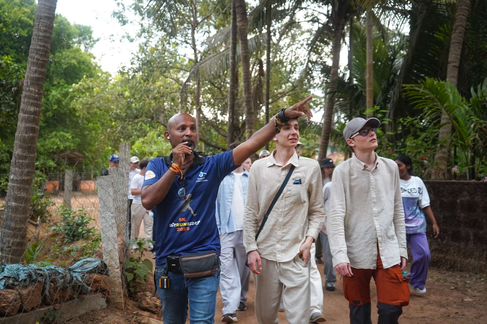A Reality tour leader pointing out local sights to students and youth travelers on a School & College Tour