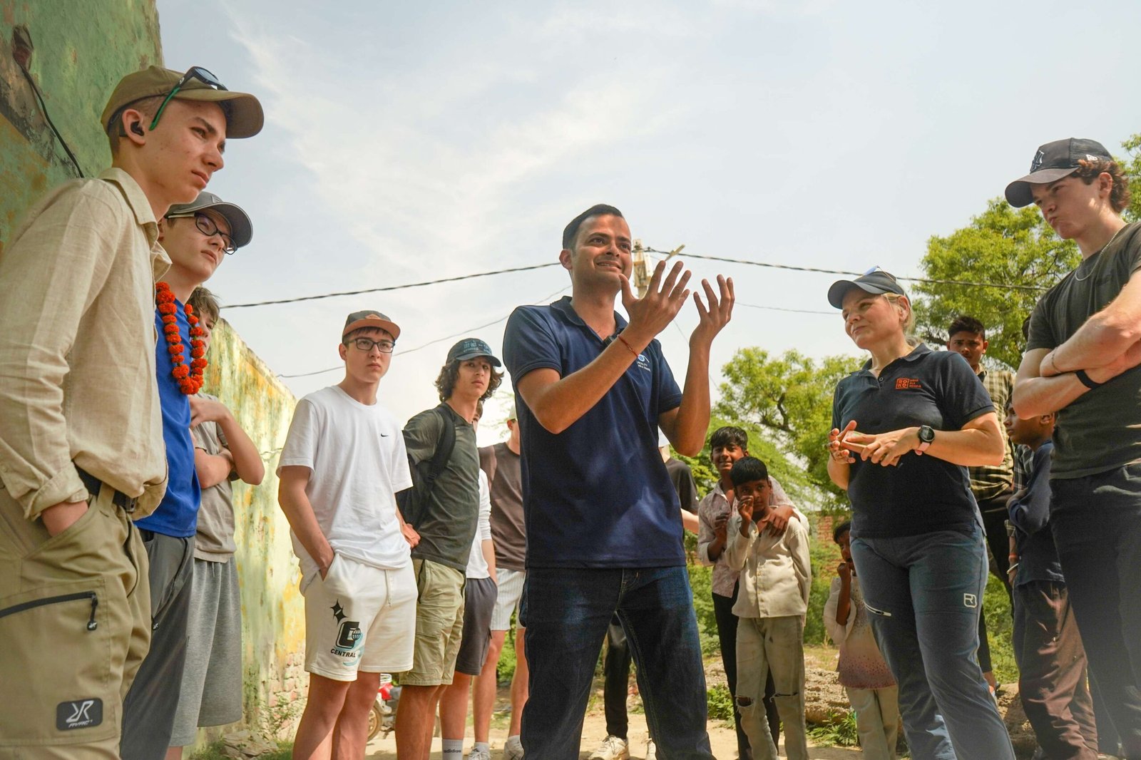 A professional Reality Tour guide sharing historical insights with an engaged group of travelers on the Golden Triangle Tour.